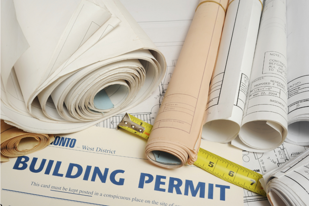 Building permit paperwork and blueprints illustrating home renovation permit requirements