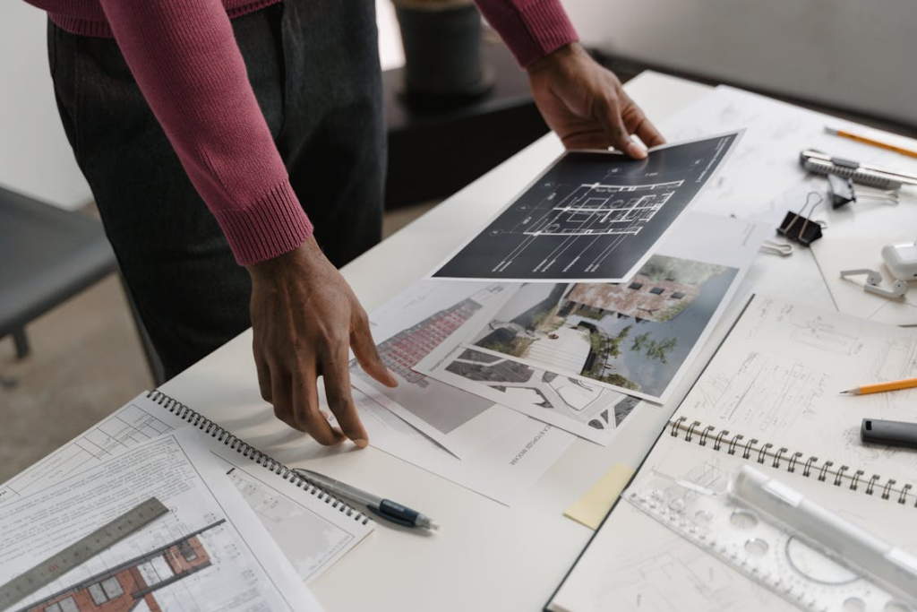 Homeowner reviewing architectural plans illustrating how to scope a home renovation before hiring contractors