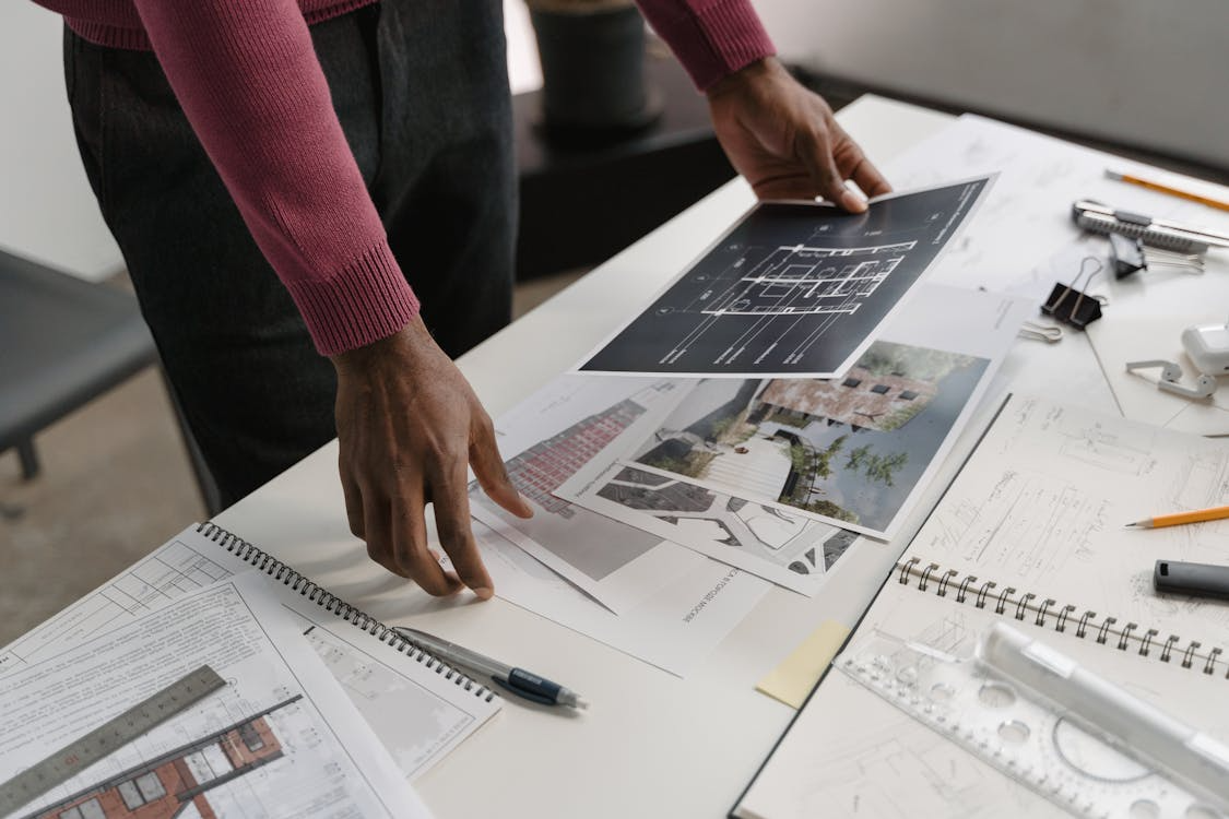 Homeowner reviewing architectural plans illustrating how to scope a home renovation before hiring contractors