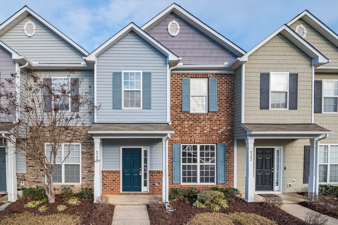 Exterior siding replacement options featuring vinyl, brick, and shingle-style siding.